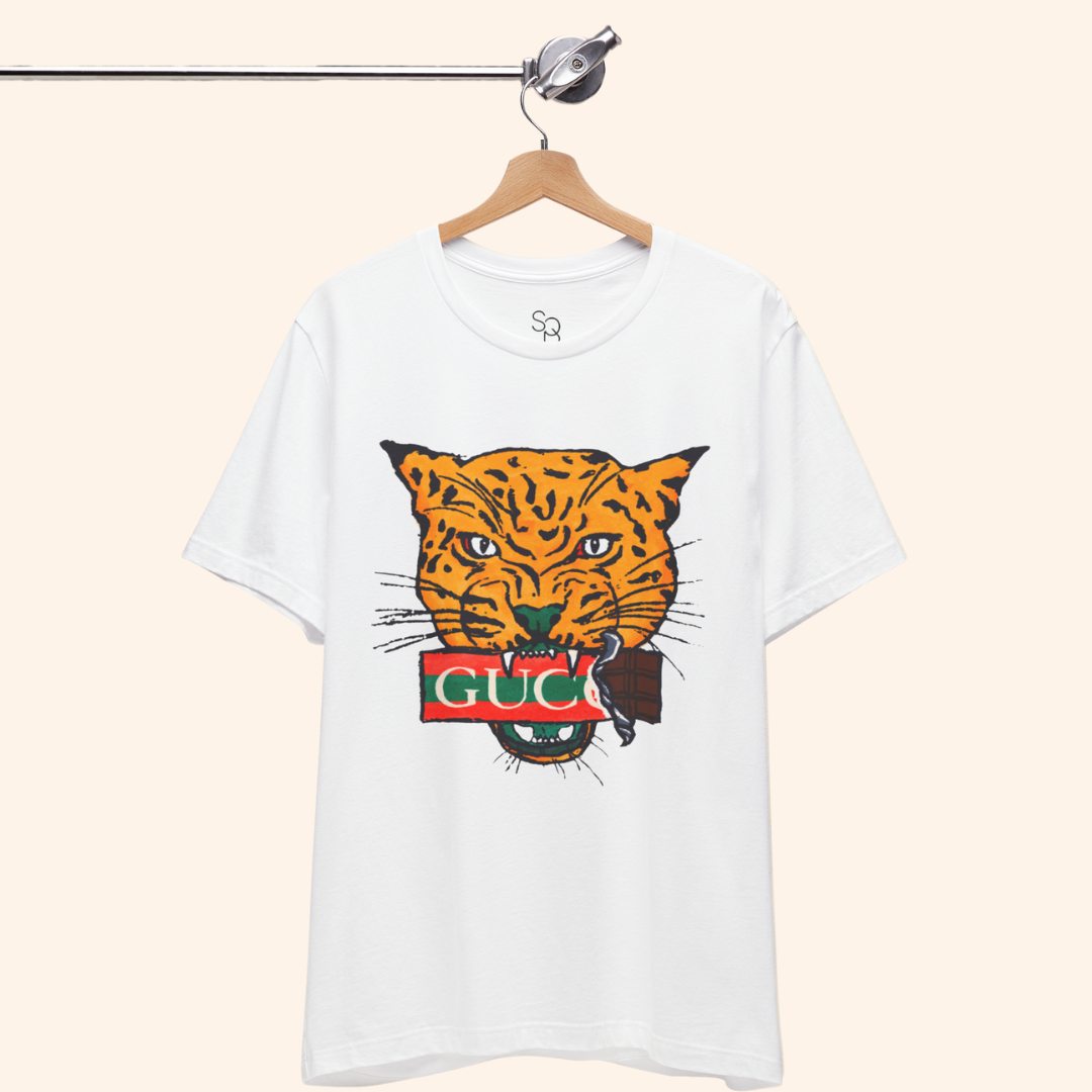 All Mine Street Style Graphic Tee hanging on wooden hanger against neutral background showing bold orange tiger design on white cotton shirt