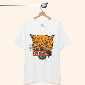 All Mine Street Style Graphic Tee hanging on wooden hanger against neutral background showing bold orange tiger design on white cotton shirt