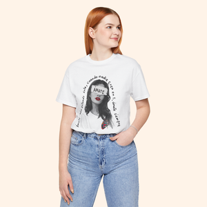 Model wearing white Amate graphic tee with jeans, standing confidently. Shows quote design placement and casual streetwear styling.