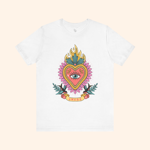 White sacred heart graphic tee in flat lay, centered design with eye inside heart, swallows and roses at base; casual street style fashion shirt.