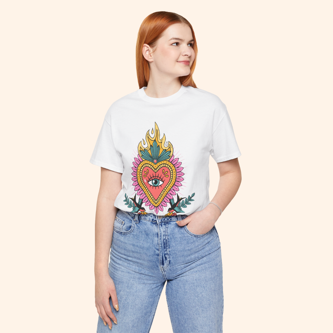 Model wearing white sacred heart graphic tee with jeans; mid-frame view shows full artwork and relaxed unisex fit for everyday wear.