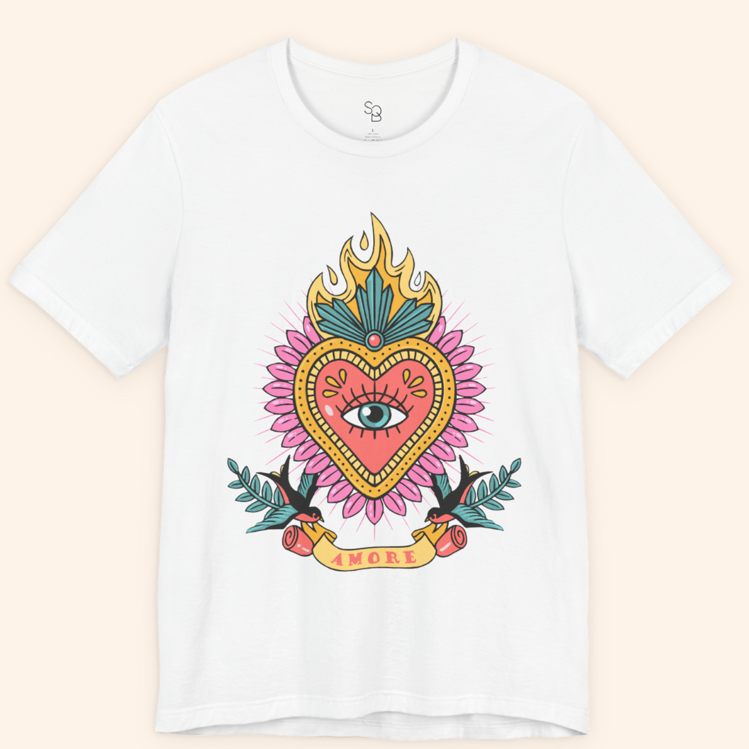 Front-on flat lay of white Amore T-Shirt with bold pink and gold heart, teal flames, and banner reading Amore; modern graphic tee.