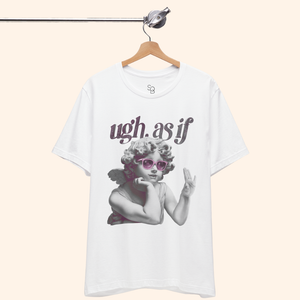 White graphic t-shirt hanging from a metal rod with “ugh. as if” text and angel wearing pink sunglasses, shot against neutral background.