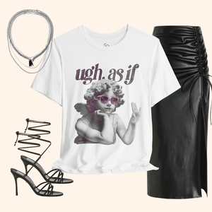 White graphic tee styled with black ruched leather skirt, lace-up heels, and layered silver necklaces – editorial outfit inspiration for night-out look.