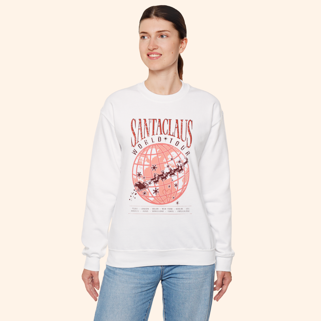 Model wearing Santas World Tour sweatshirt with hands in pockets, showing front tour graphic with globe and sleigh design, festive casual outfit for women, Christmas street style.