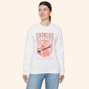 Model wearing Santas World Tour sweatshirt with hands in pockets, showing front tour graphic with globe and sleigh design, festive casual outfit for women, Christmas street style.