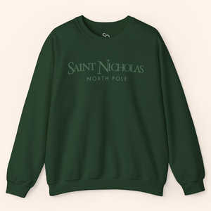 Forest-green Saint Nicholas Christmas Sweatshirt laid flat; clean crewneck construction and minimalist print, ideal for boutique holiday collections.