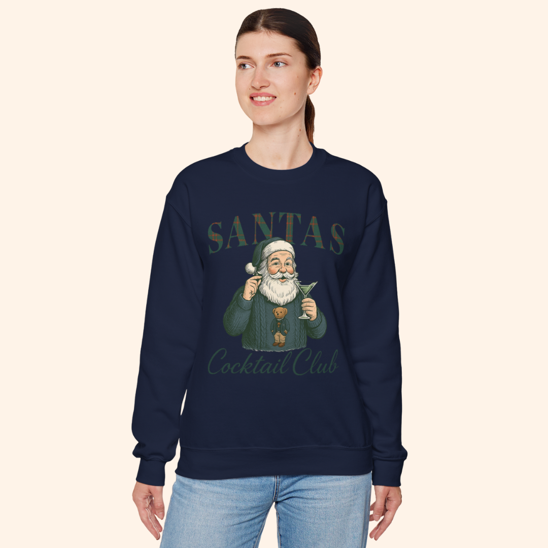Model wearing navy vintage style Santas Cocktail Club sweatshirt, smiling and posing in relaxed winter outfit featuring holiday graphic design.