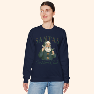Model wearing navy vintage style Santas Cocktail Club sweatshirt, smiling and posing in relaxed winter outfit featuring holiday graphic design.