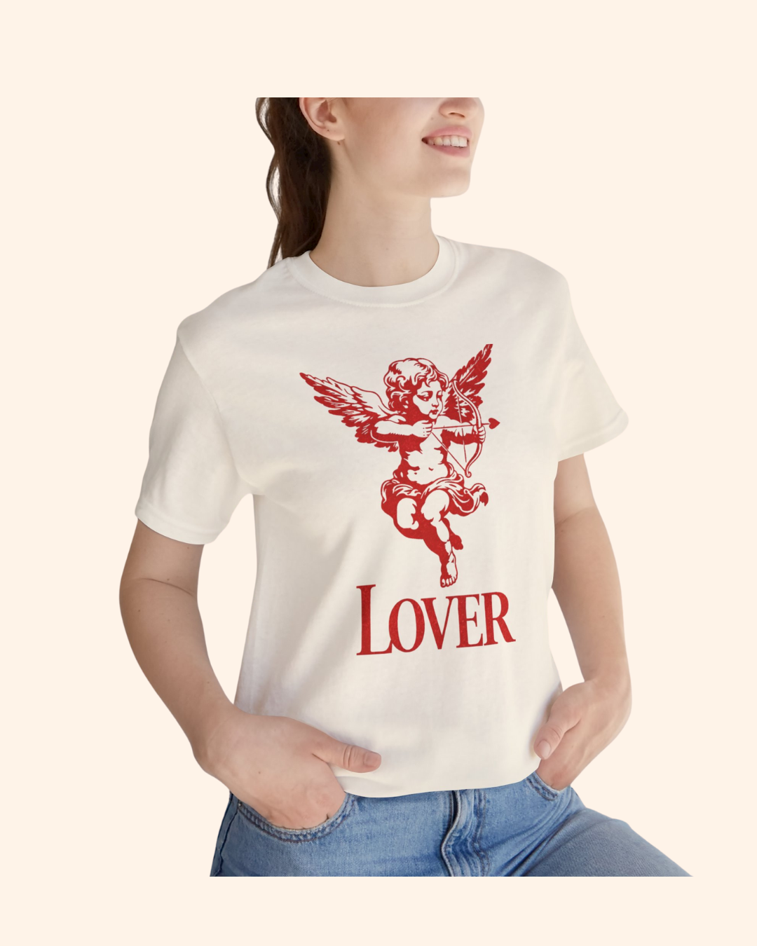 Close up of a woman wearing a natural color graphic tee with red cupid cherub artwork and lover text, styled casually.