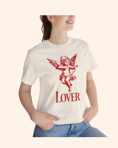 Close up of a woman wearing a natural color graphic tee with red cupid cherub artwork and lover text, styled casually.