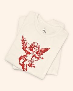 Folded natural color t shirt stacked neatly, highlighting the red cupid cherub graphic partially visible on the front.