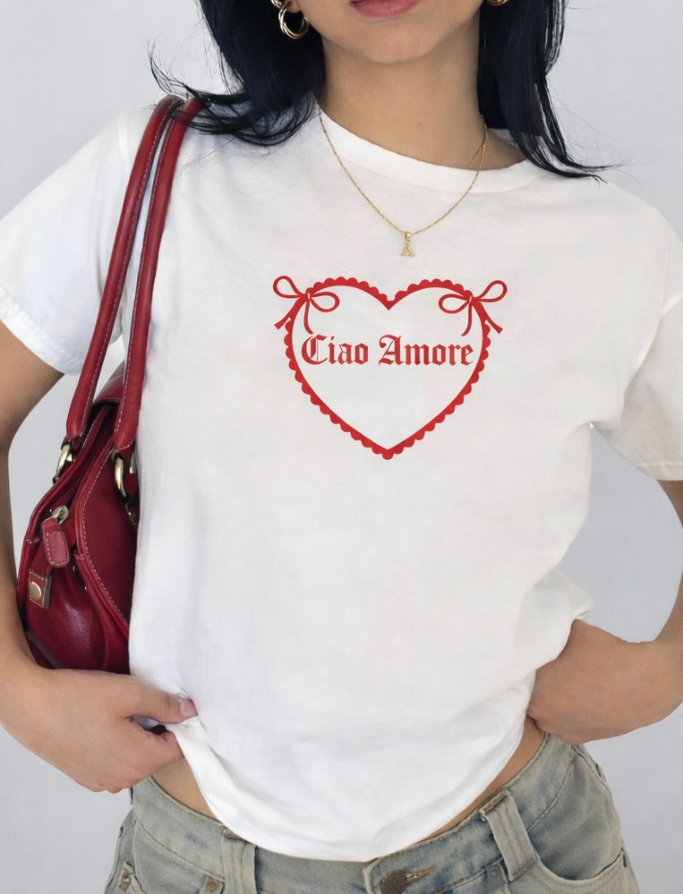 Styled outfit flat lay featuring white graphic tee paired with jeans handbag and heels for a date night look.