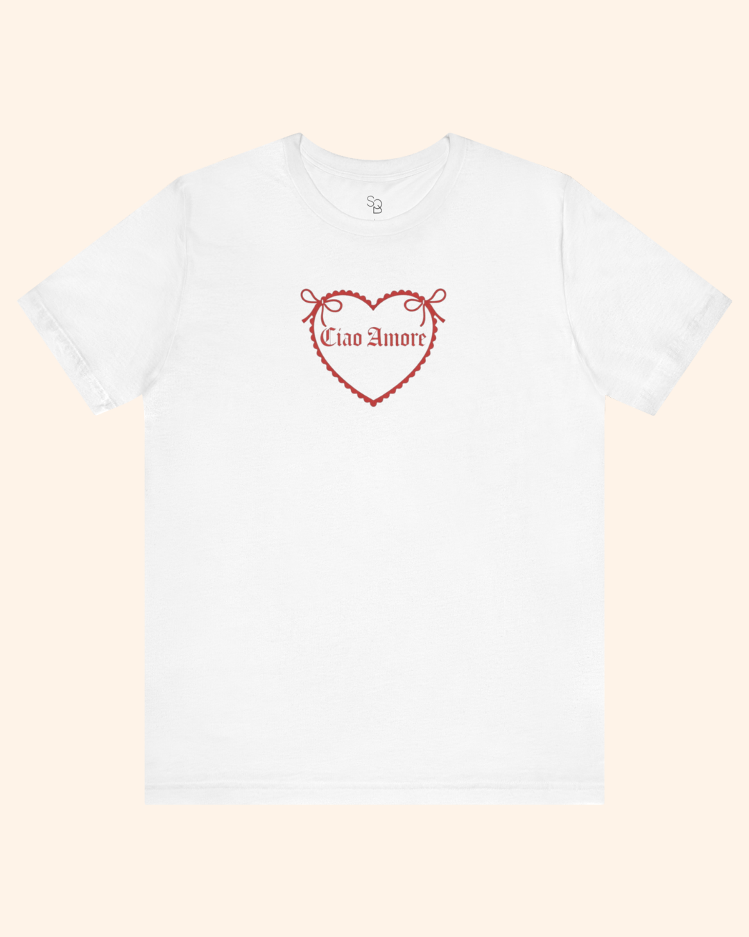 White graphic tee laid flat with centered heart design and romantic phrase, styled for a minimal product flat lay.