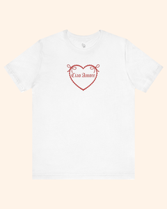 White graphic tee laid flat with centered heart design and romantic phrase, styled for a minimal product flat lay.