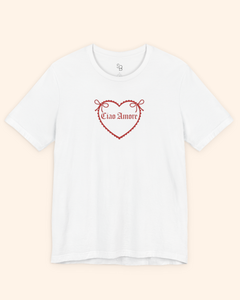 Overhead flat lay of white heart graphic t shirt photographed on a neutral background, highlighting the clean design.