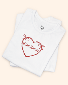 Folded white cotton graphic tee showing neckline and partial heart print, styled for product presentation.