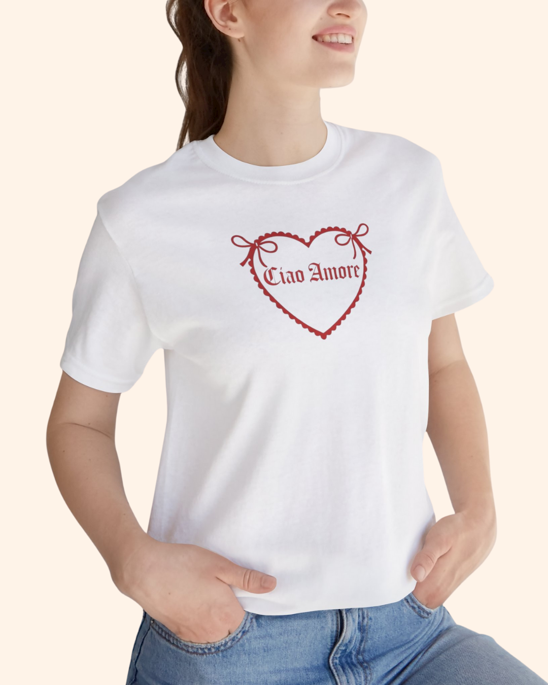 Close up of model wearing white graphic tee with red heart design, styled casually with a confident street style vibe.