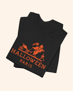 Folded black Midnight in Paris graphic tee with coral-orange carriage design