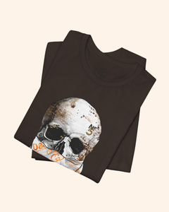 Folded brown All or Nothing graphic tee showing the weathered skull artwork