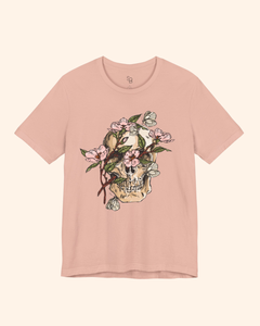 Peach Spring With You tee with skull, pink flowers, green leaves, and butterflies