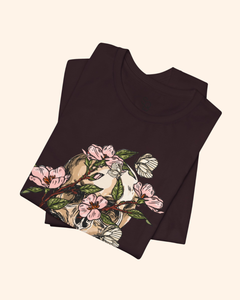 Folded Oxblood Black Spring With You tee showing the botanical skull artwork