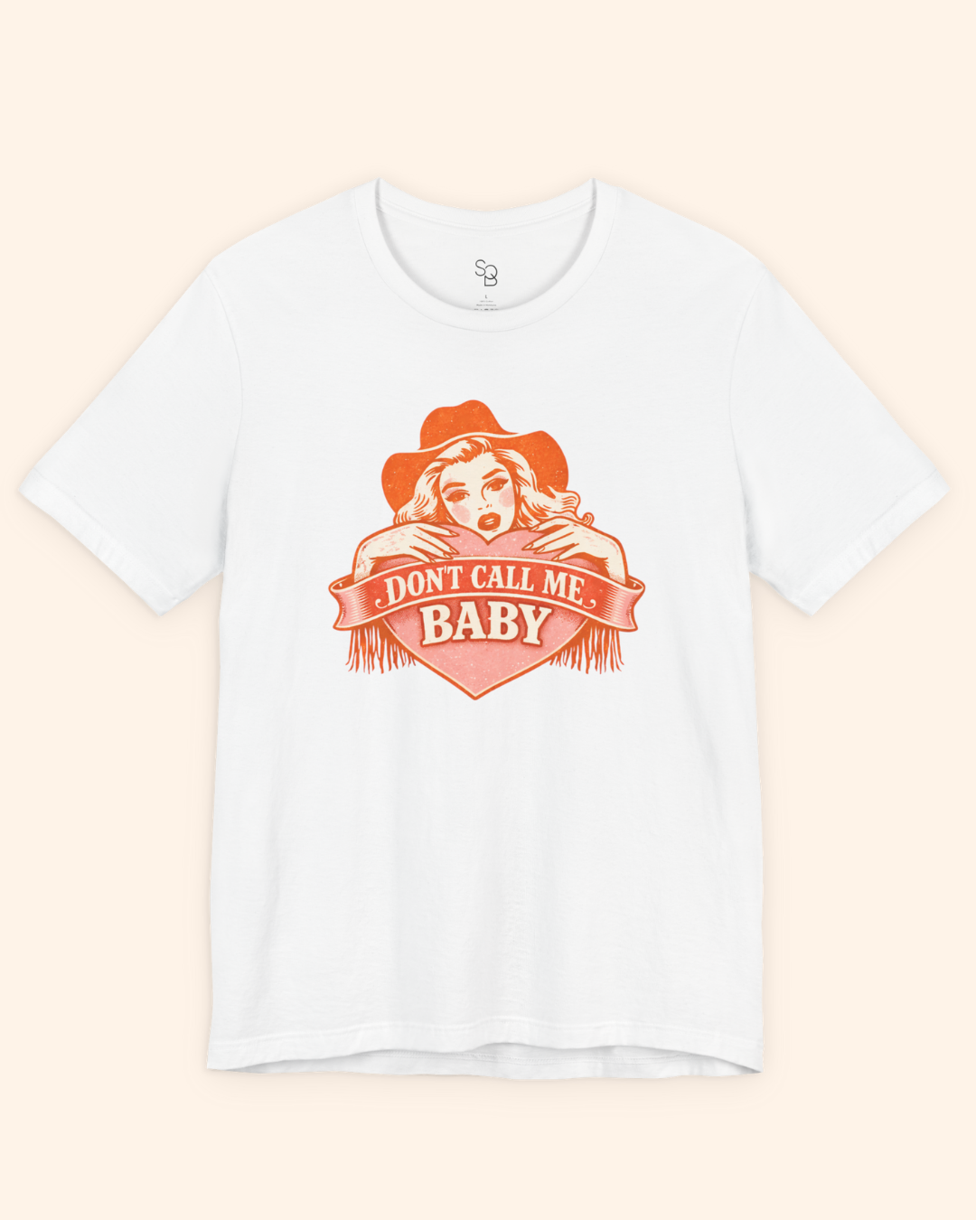Flat lay of a white western graphic tee with orange heart artwork and Dont Call Me Baby lettering, styled clean and minimal for product detail.