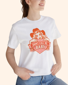 Close up of a woman wearing a white western graphic tee with Dont Call Me Baby design, focusing on the chest graphic and neckline detail.