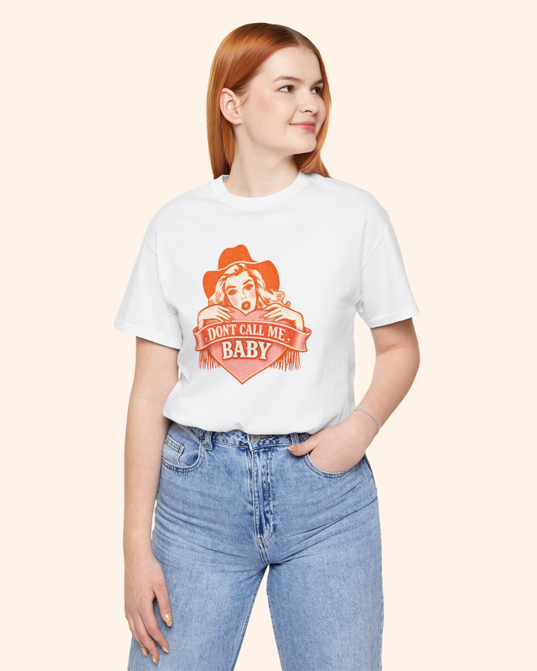 Mid size woman wearing white Don’t Call Me Baby western graphic t-shirt styled with jeans, front view showing relaxed unisex fit.