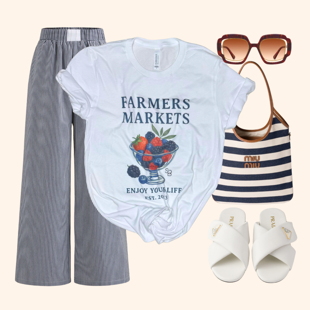 Graphic tee styled with striped pants, designer sandals, oversized sunglasses, and a tote bag. A complete look for markets, brunch, or city weekends.

