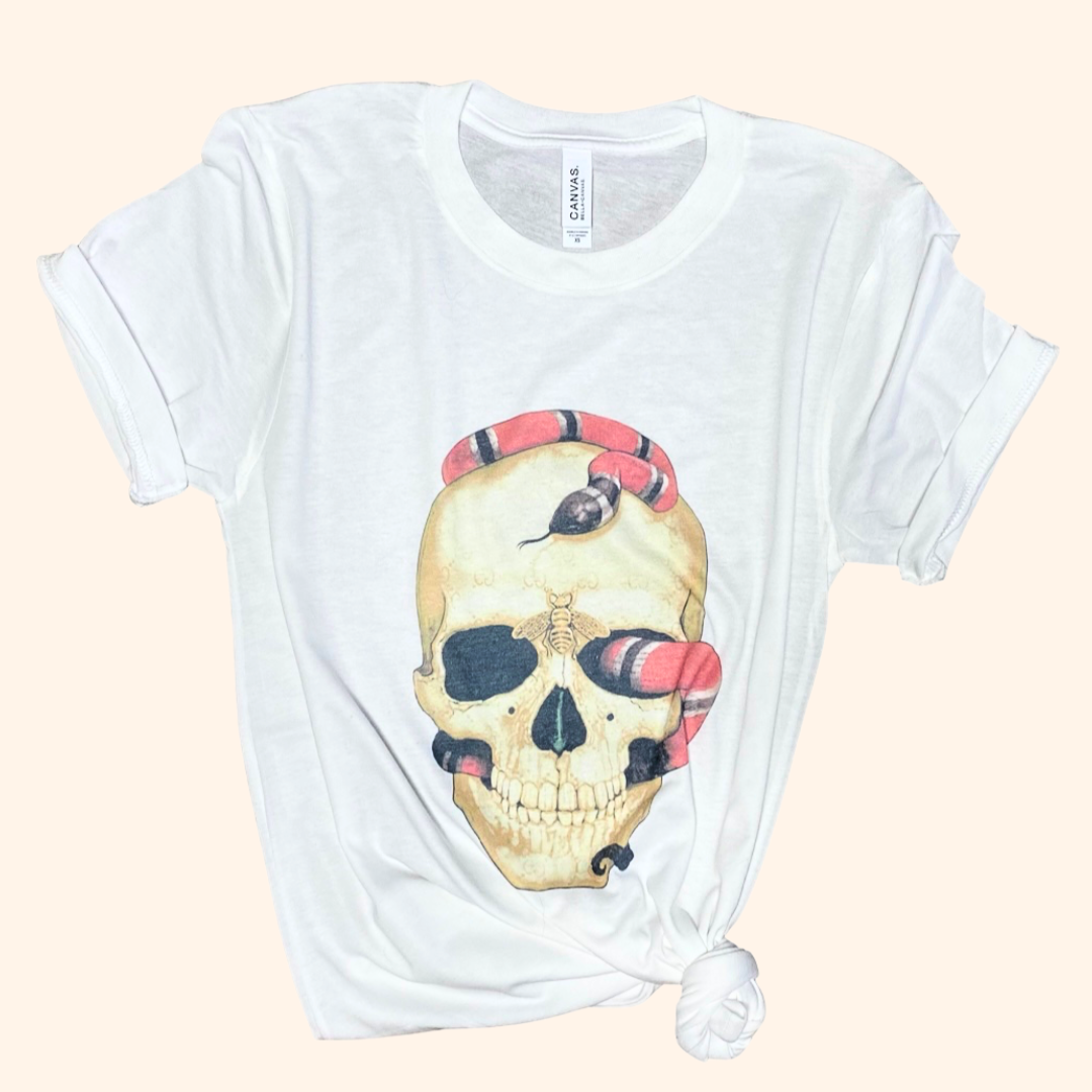 White skull snake graphic tee tied at hem flat lay, casual display