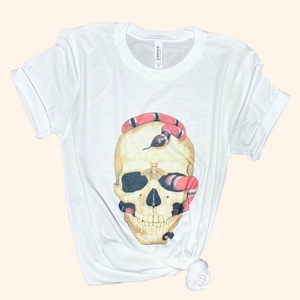 White skull snake graphic tee tied at hem flat lay, casual display