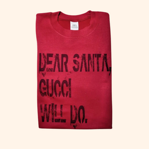 Folded red “Dear Santa” sweatshirt on a neutral surface, displayed as a solo flat lay product image.

