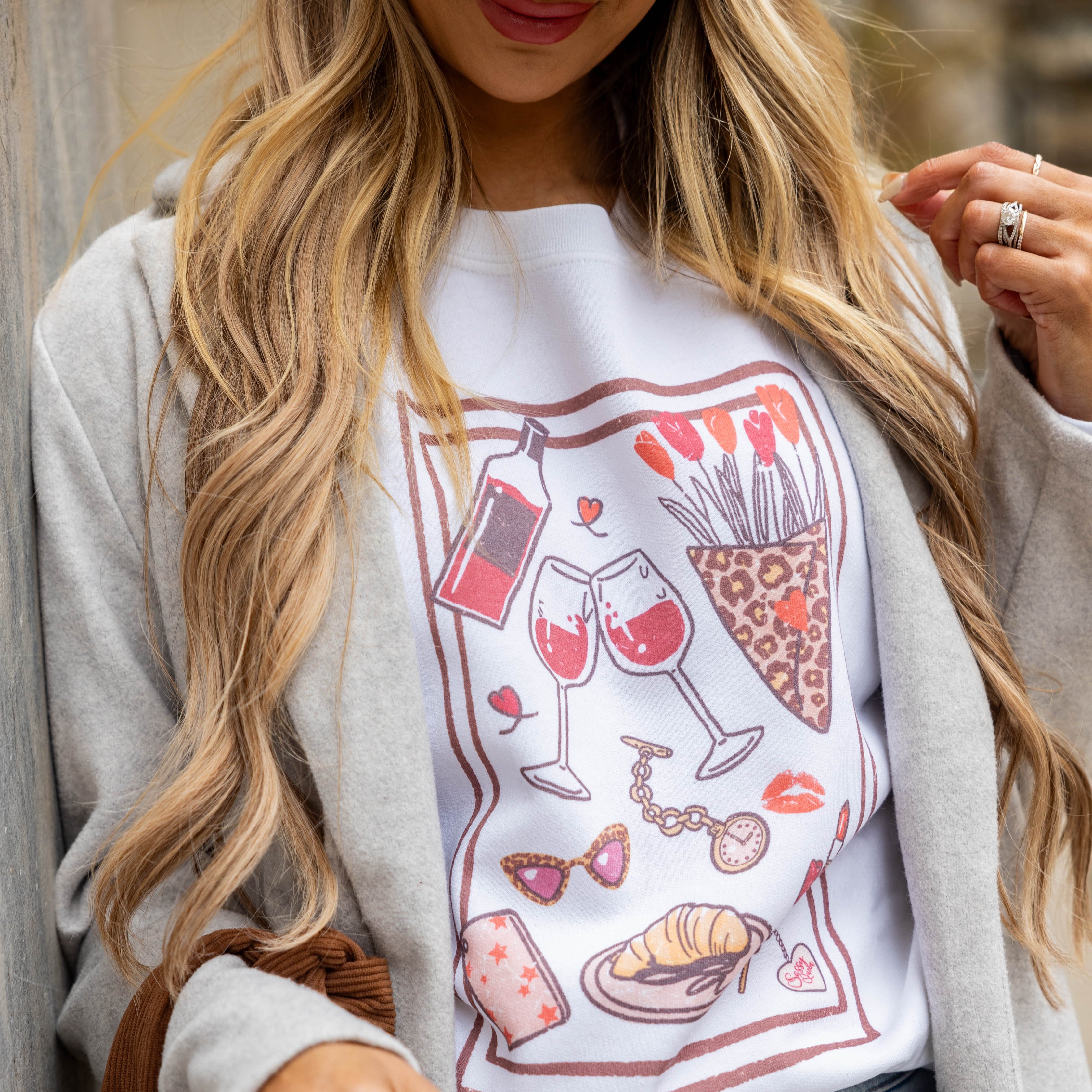 Woman wearing Date Night sweatshirt with leopard cap, grey coat, and jeans — styled for casual date nights or weekend trips.