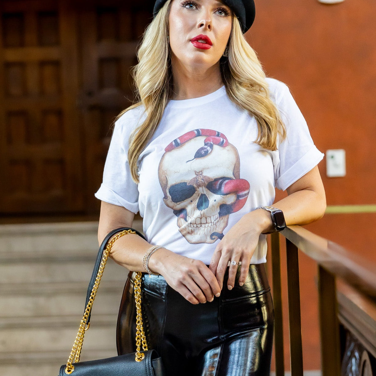 Casual edgy outfit with skull snake graphic tee styled on steps