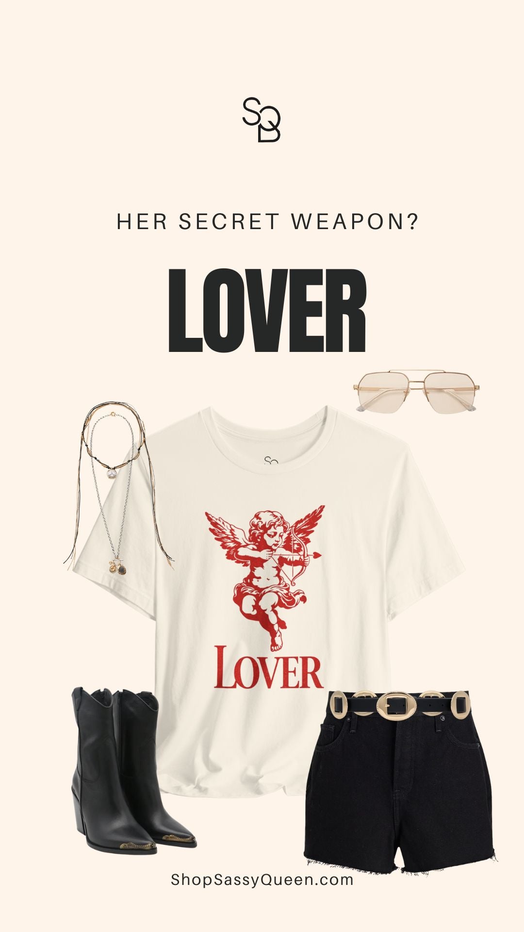 Styled product poster showing natural color Lover graphic tee with red cherub artwork, western boots, black shorts, layered necklaces, and bold typography