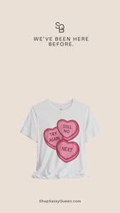 Product video showcasing a white graphic t-shirt with pink candy heart design reading Try Again, Still No, and Next, highlighting the front print, fit, and fabric texture in a clean studio style presentation.