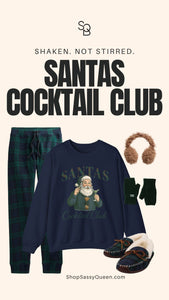 Cozy winter themed flat lay with navy Santas Cocktail Club sweatshirt, plaid loungewear pants, fuzzy earmuffs, fingerless gloves, and warm plaid slippers.