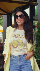 Model wearing the Fresh Start graphic tee featuring lemon artwork and bold text, styled with denim and a yellow blazer in a sunny outdoor setting — perfect for showcasing a women's retro boho shirt on Shopify.